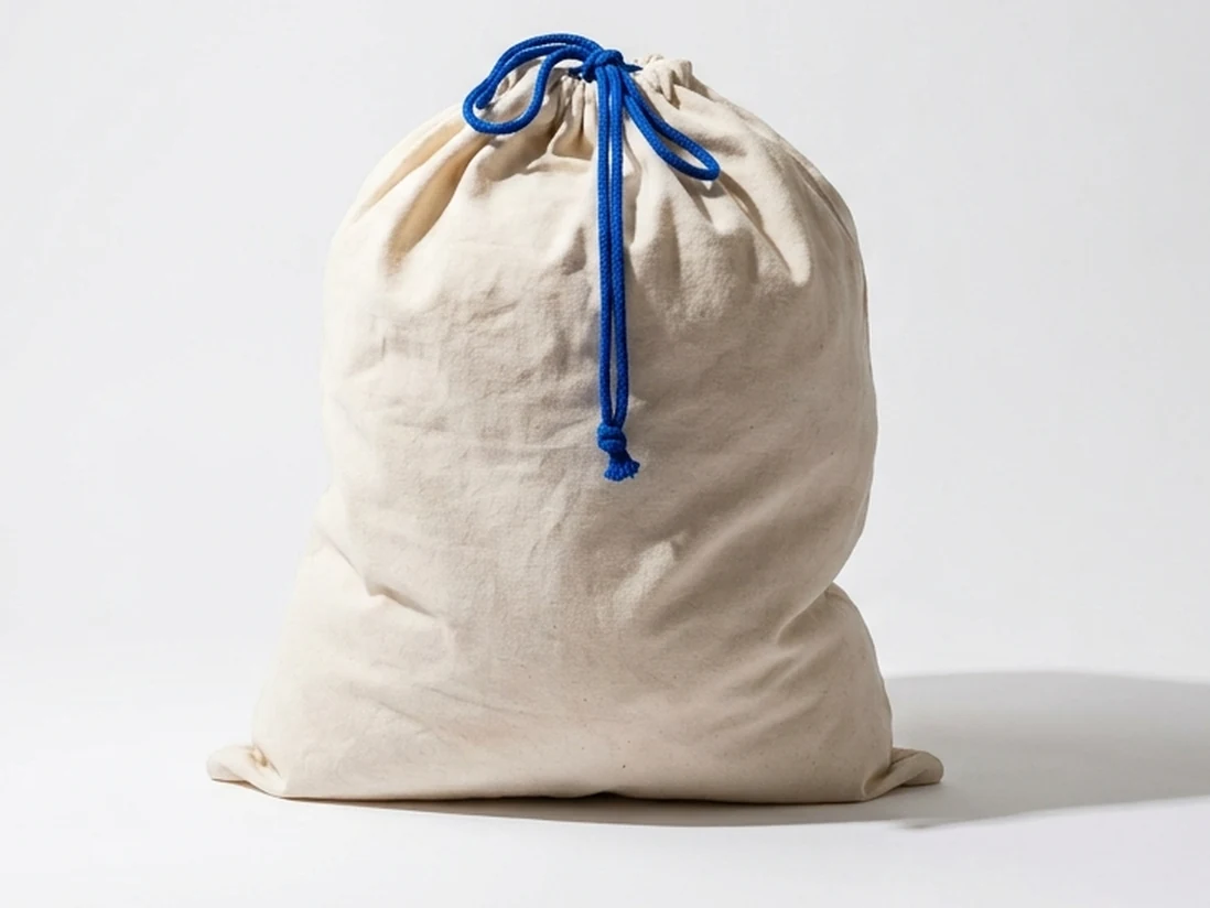 An off-white canvas Everlast laundry bag with a blue drawstring, tied and full