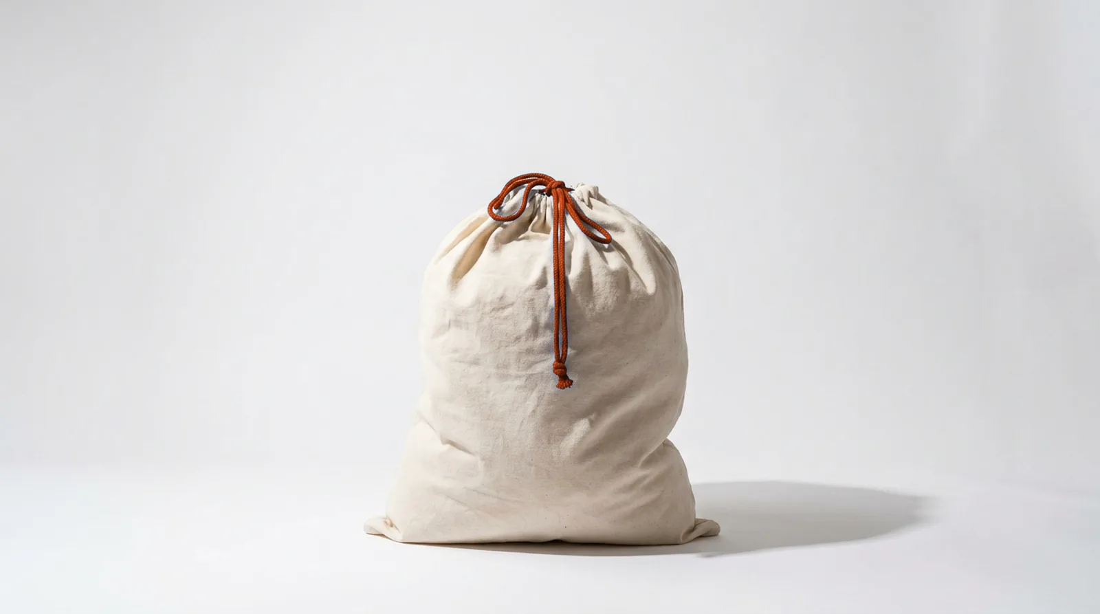 A canvas laundry bag tied with a drawstring